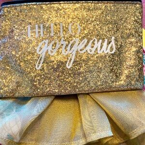 Gold metallic top zip cosmetic or inside purse bag. GUC “Hello Gorgeous”